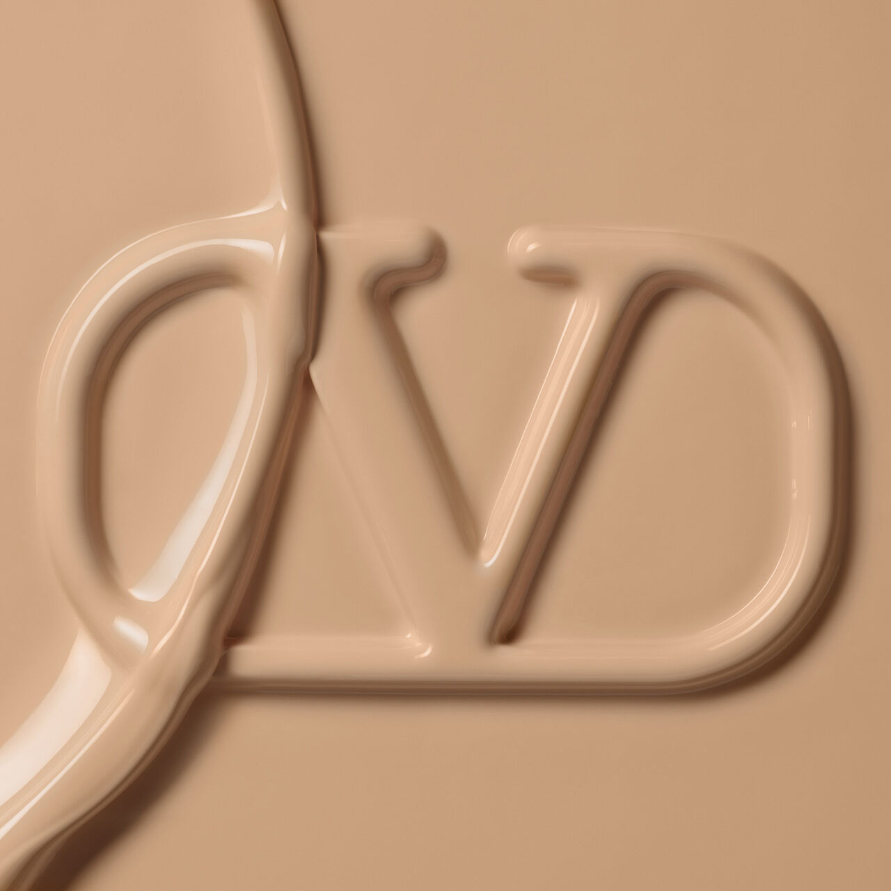 A close-up of a creamy, beige product with a stylized "DV" logo partially submerged in the texture.