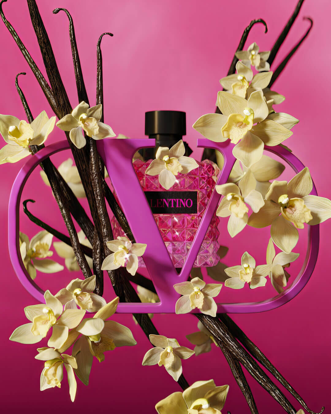 A pink Valentino perfume bottle surrounded by yellow orchids and vanilla pods, set against a vibrant pink background.