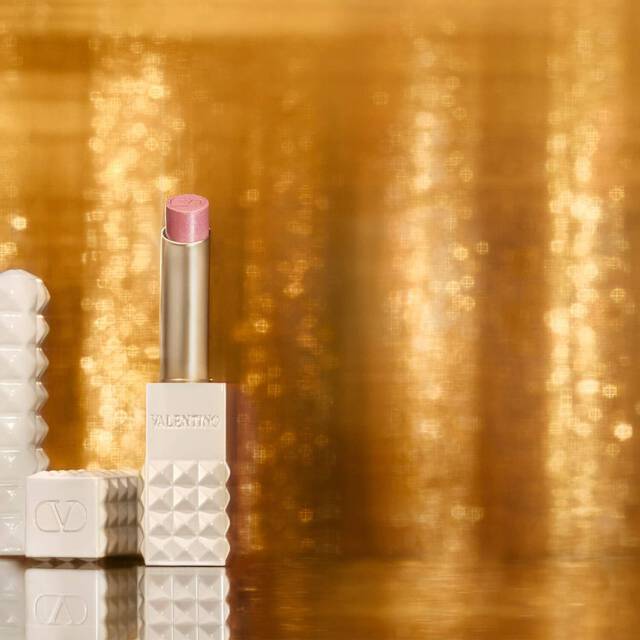 SPIKE VALENTINO IVORY placed against a backdrop of shimmering gold