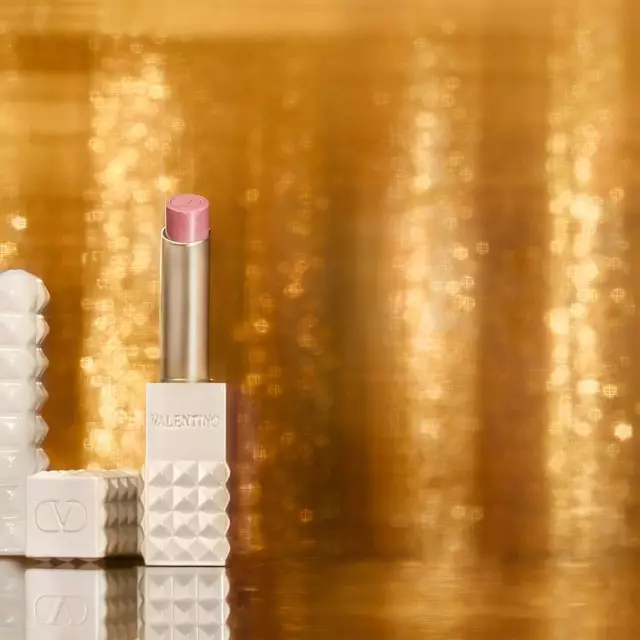 SPIKE VALENTINO IVORY placed against a backdrop of shimmering gold