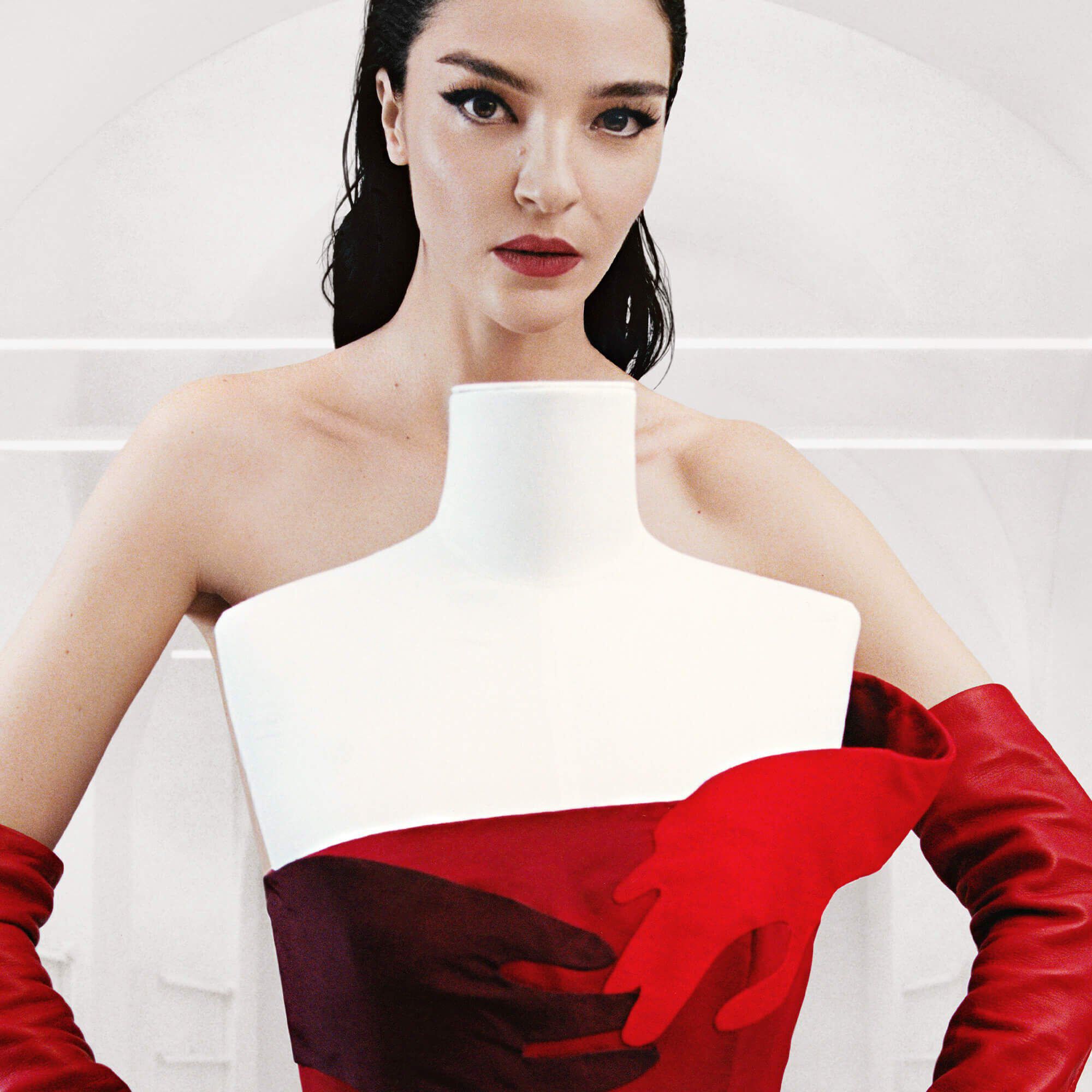 A collage of four models wearing striking red dresses and makeup, showcasing various styles and textures, including bows and sequins, against a minimalist backdrop. Each model has a distinct pose and expression.