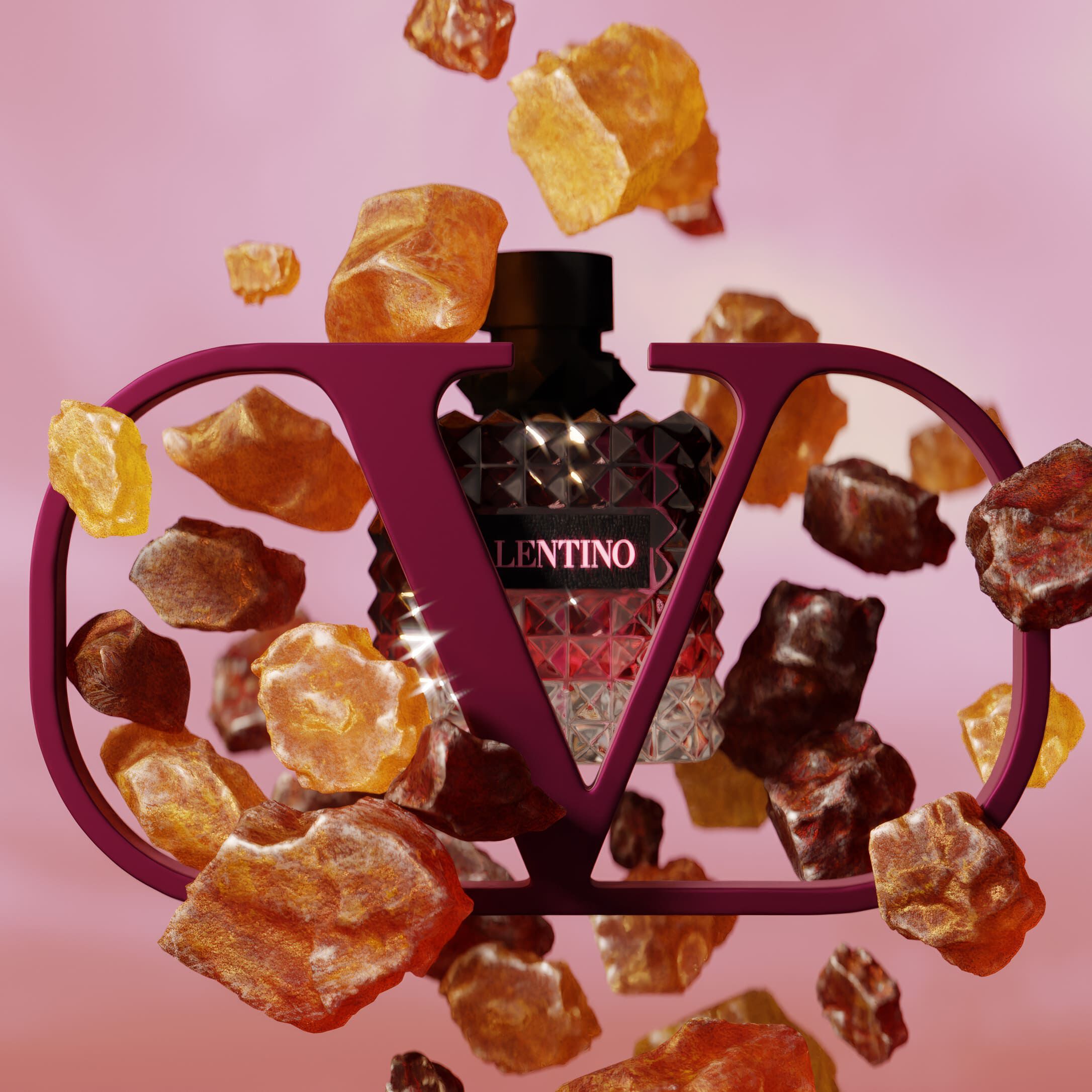 A stylish perfume bottle surrounded by glowing amber stones, set against a soft pink background, with the text "VALENTINO" prominently featured.