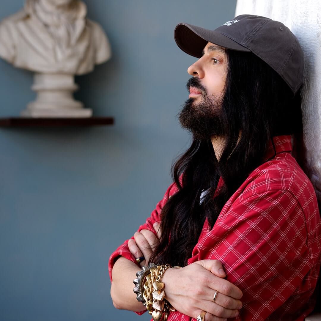Alessandro Michele, creative director of Valentino, leaning against the wall.
