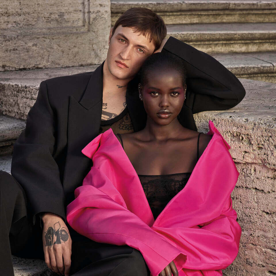 Two Valentino beauty models leaned against each other.