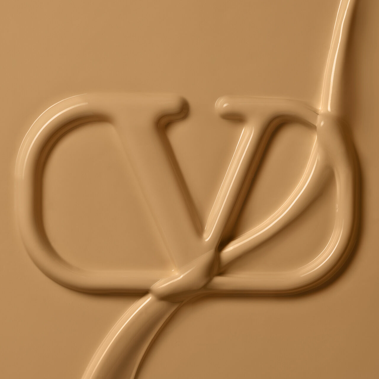 An abstract image featuring a stylized logo or emblem in a smooth, beige texture. The logo appears to be created from a thick, flowing substance, giving it a three-dimensional look.