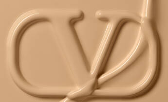 A smooth, creamy texture forming the letters "VD" in a light beige color.