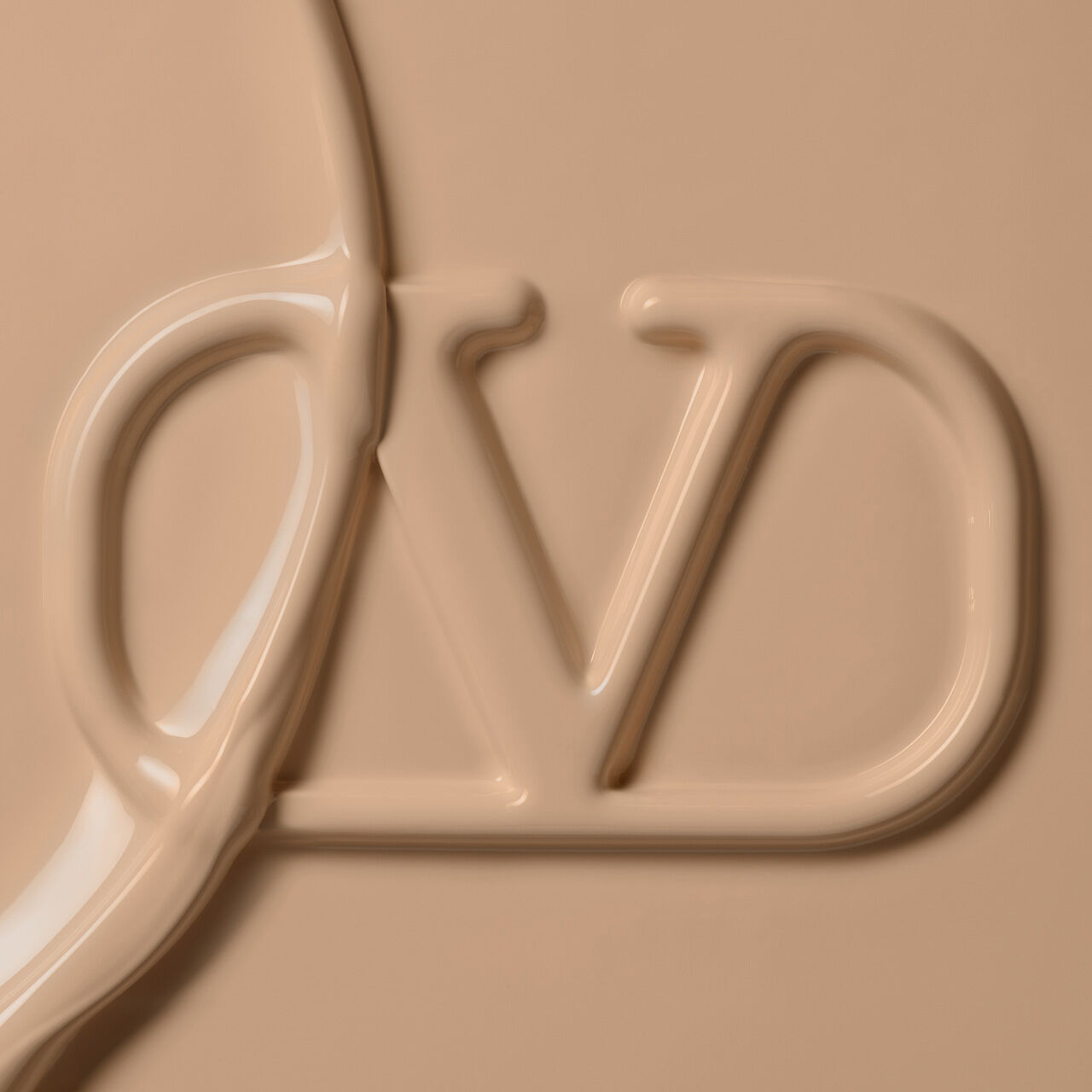 Close-up of a smooth, creamy beige product with the letters "DV" embossed in the surface.