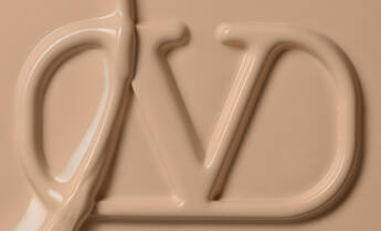 Close-up of a smooth, creamy beige product with the letters "DV" embossed in the surface.